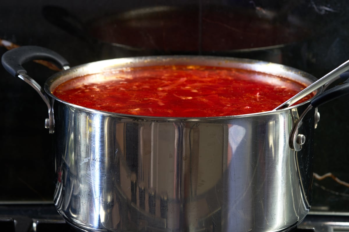 Cabbage soup simmering in a pot on the stove